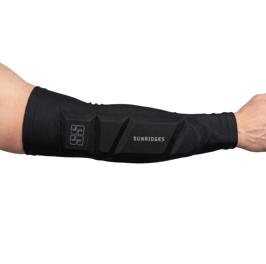 A black SunRidges arm sleeve with segmented padding and a white logo, shown worn on a person's forearm against a white background.
