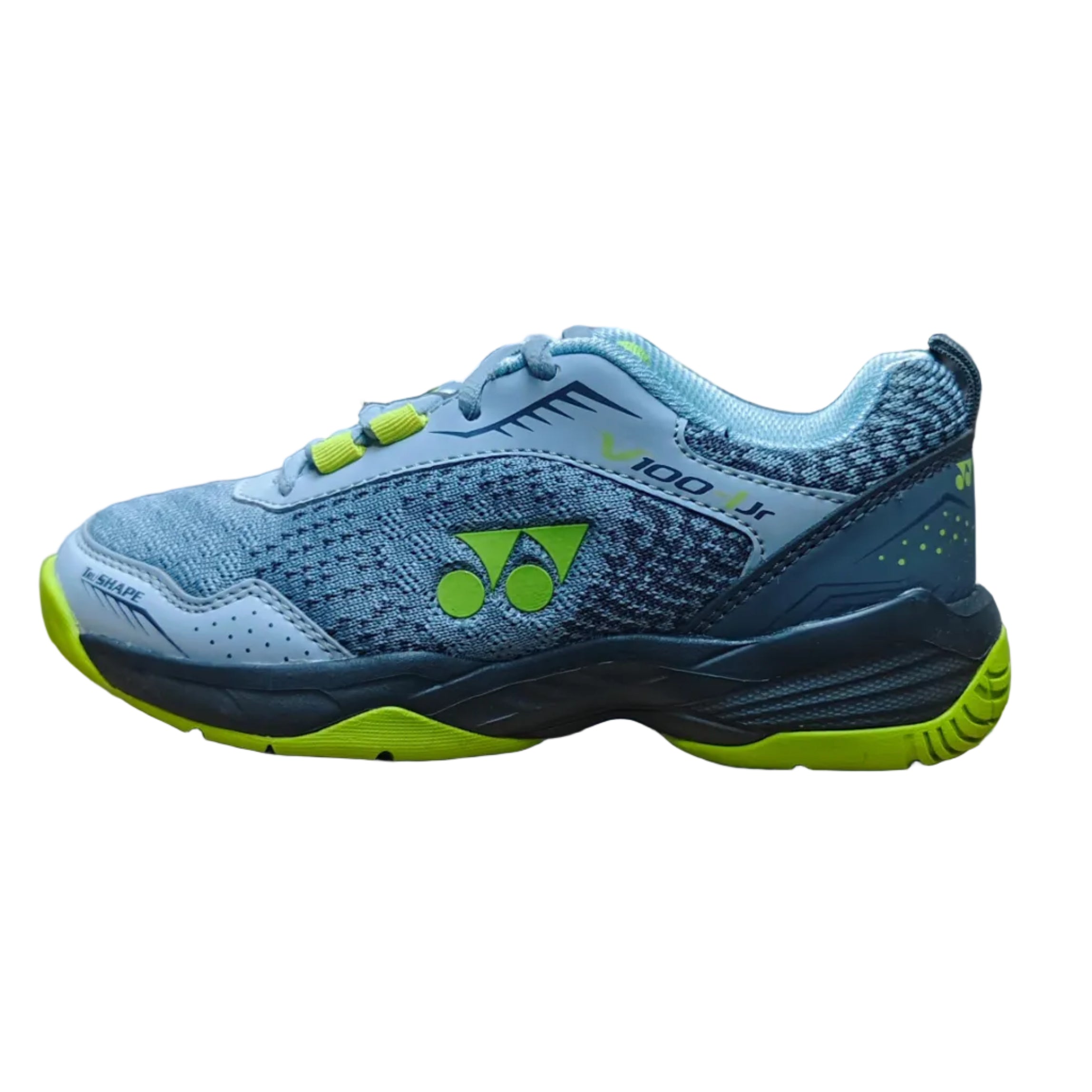Blue and green athletic shoe on a cardboard box in a warehouse setting