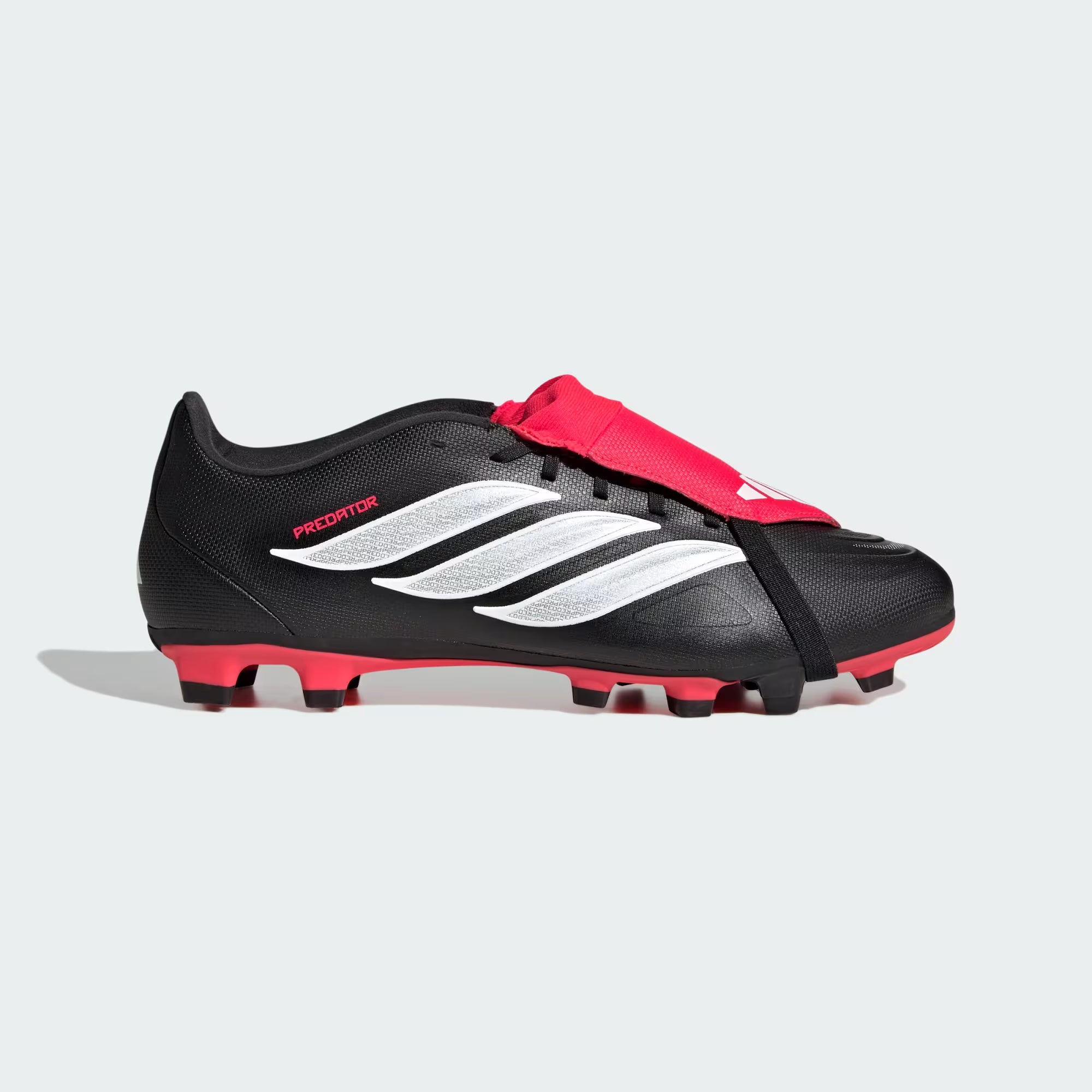 Black and red soccer cleats with white stripes on a light gray background